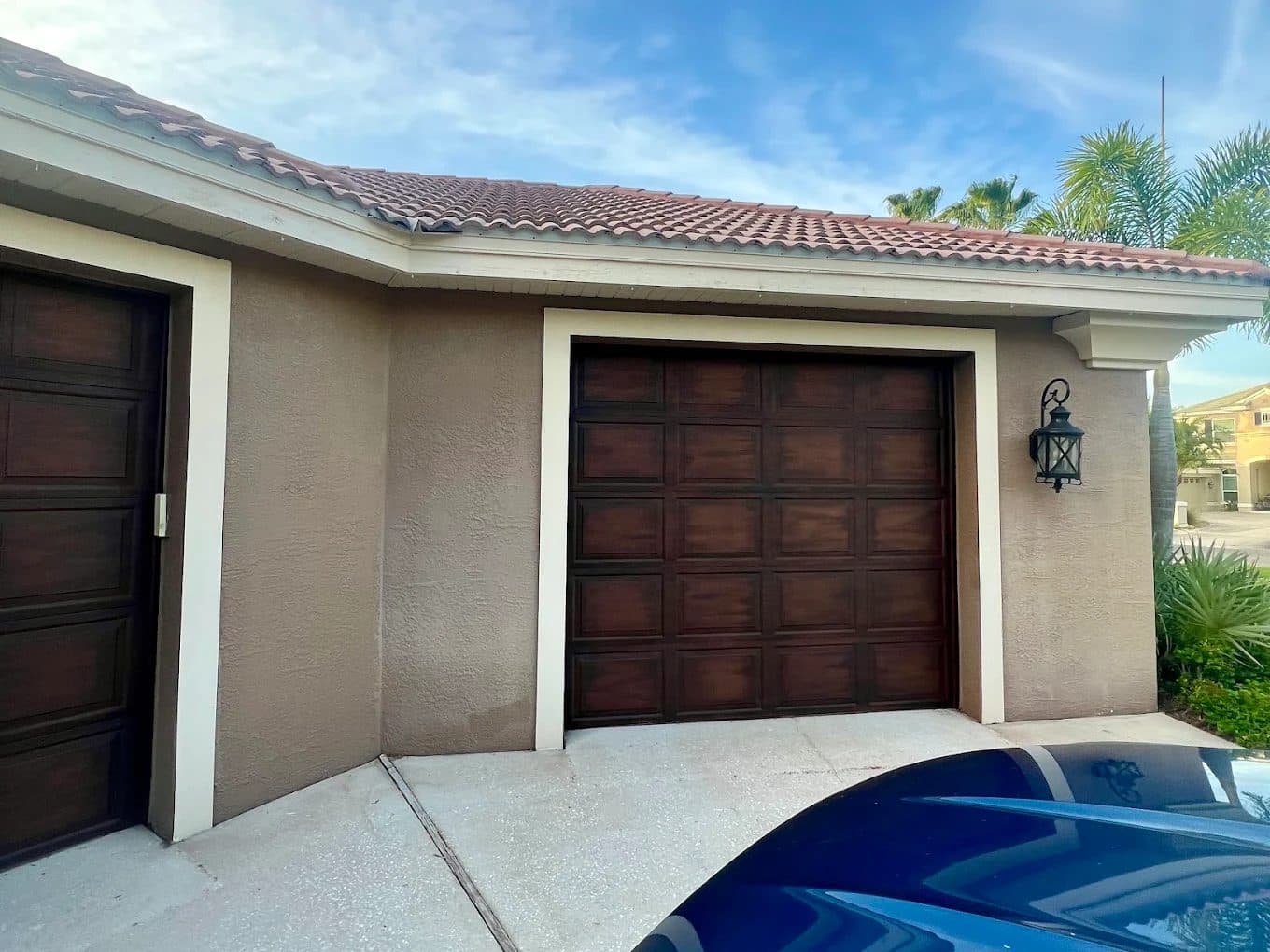 Close-up of a garage door with a hand-applied wood-grain finish