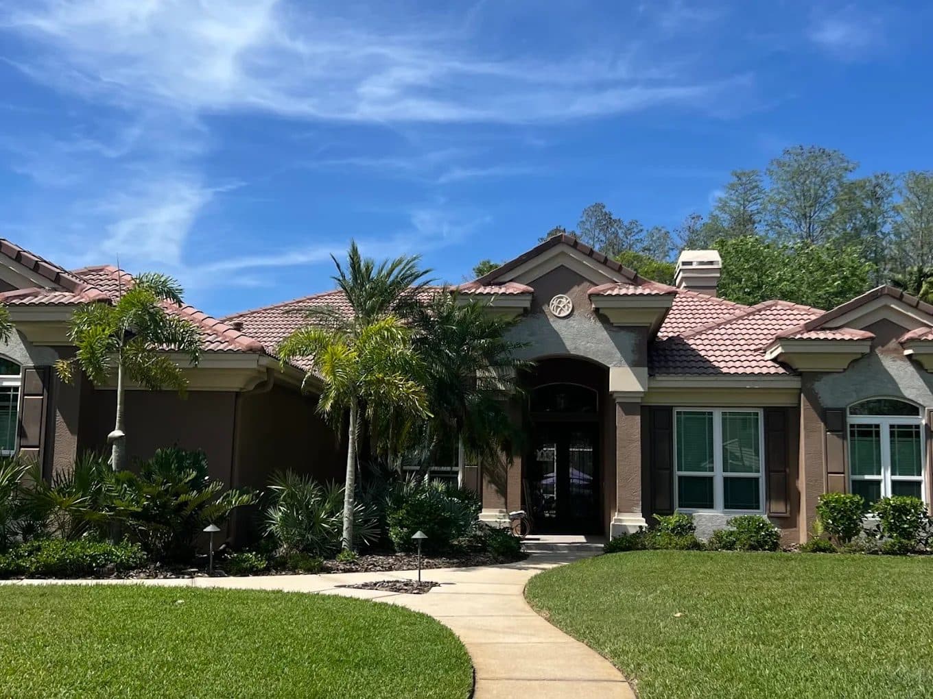 Tile-roof home with a freshly painted stucco exterior and trim